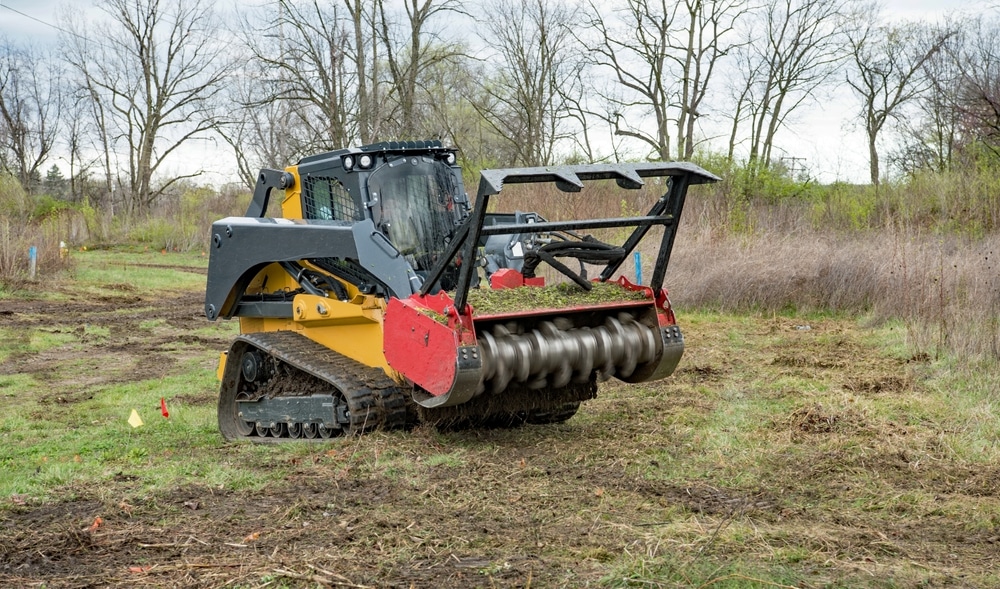 forestry,mulcher,actively,mulching,weeds,from,field,in,preparation,for
