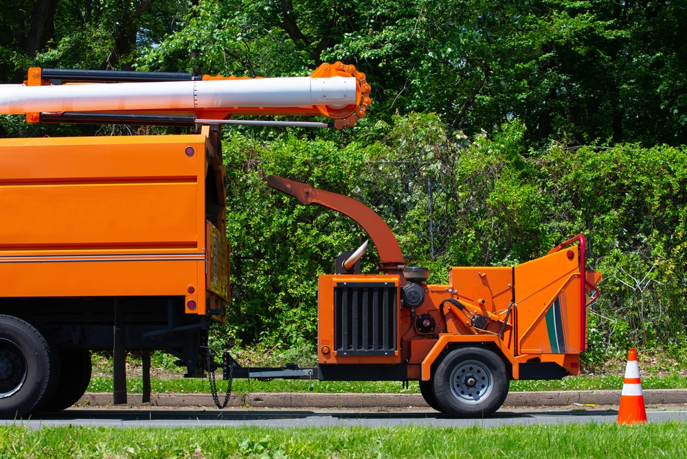 wood,chipper,machine,releasing,the,shredded,woods,into,a,truck